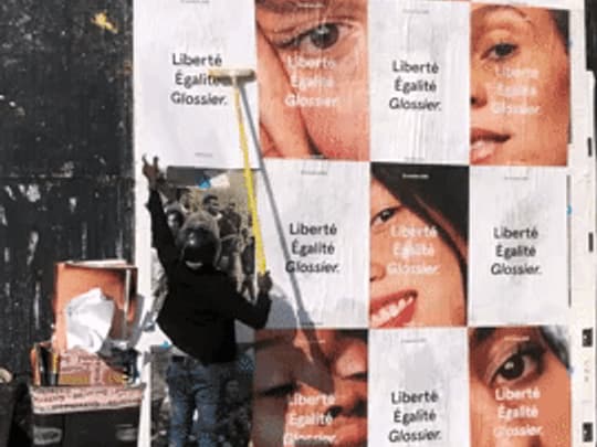 Campaign posters being wheat-pasted in Paris, Place de la Madeleine