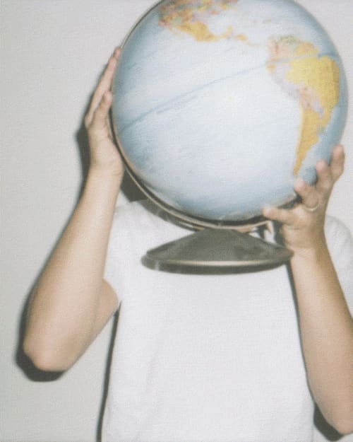 Wenonah holding a globe up in front of her face